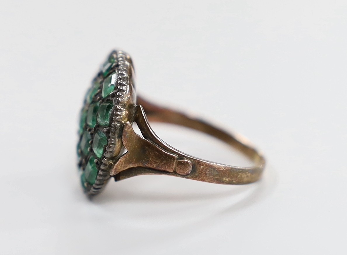 An early 19th century yellow and white metal, emerald cluster set ring, (stone missing), size O/P, gross weight 5.5 grams.